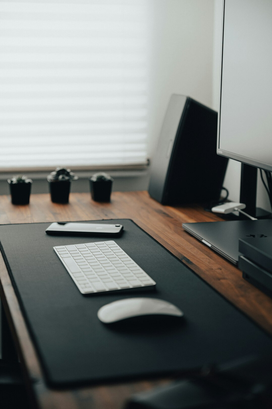 Desk setup with dual monitors showing code, keyboard and mouse