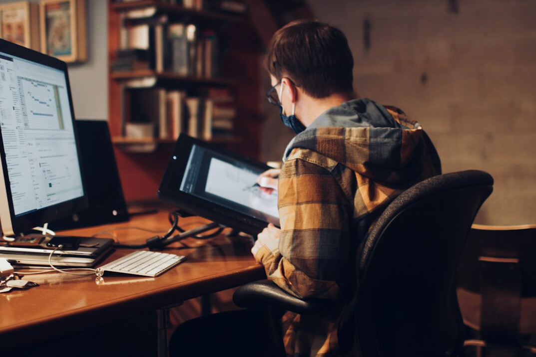 successful programmer at desk