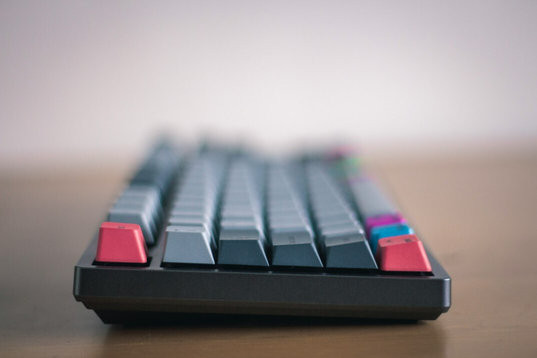 Close-up of hands typing on a mechanical keyboard