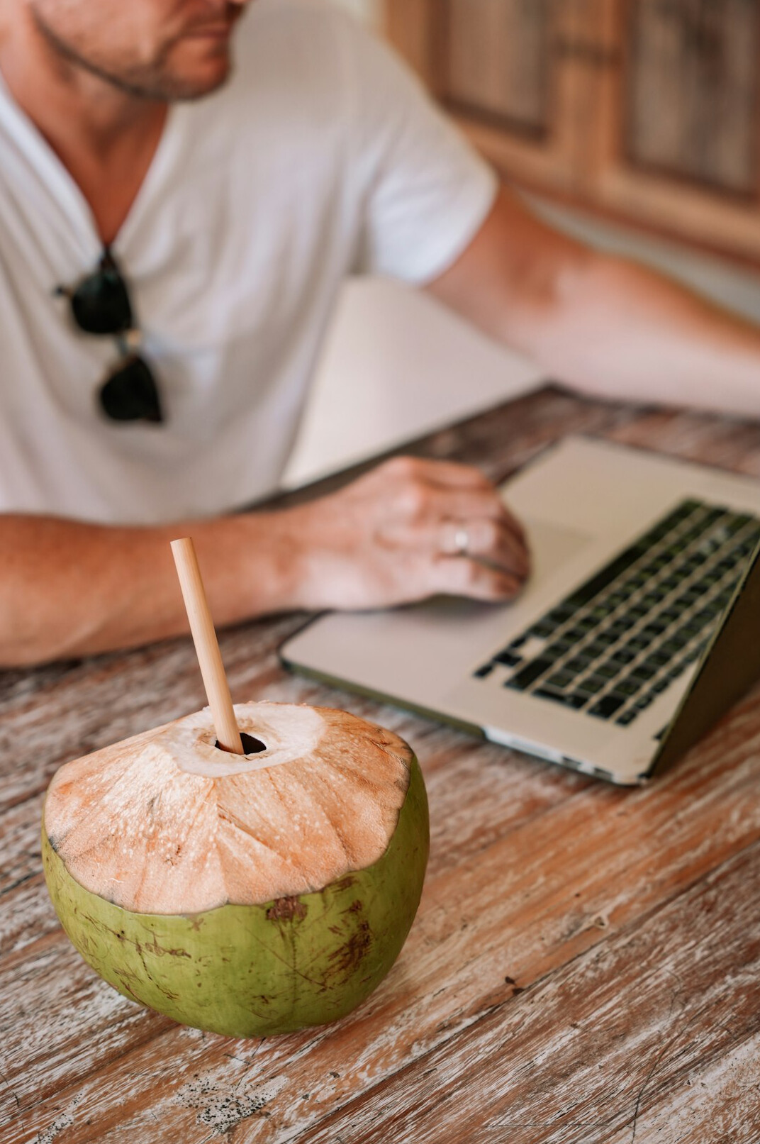 Focused man typing on a laptop in a bright home office