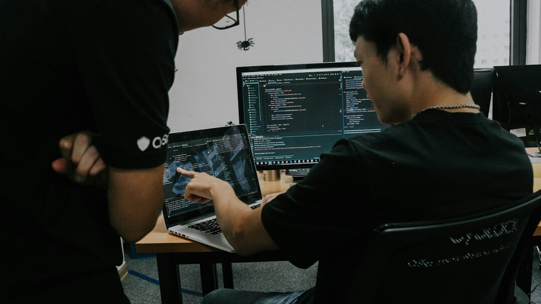 students coding on laptops